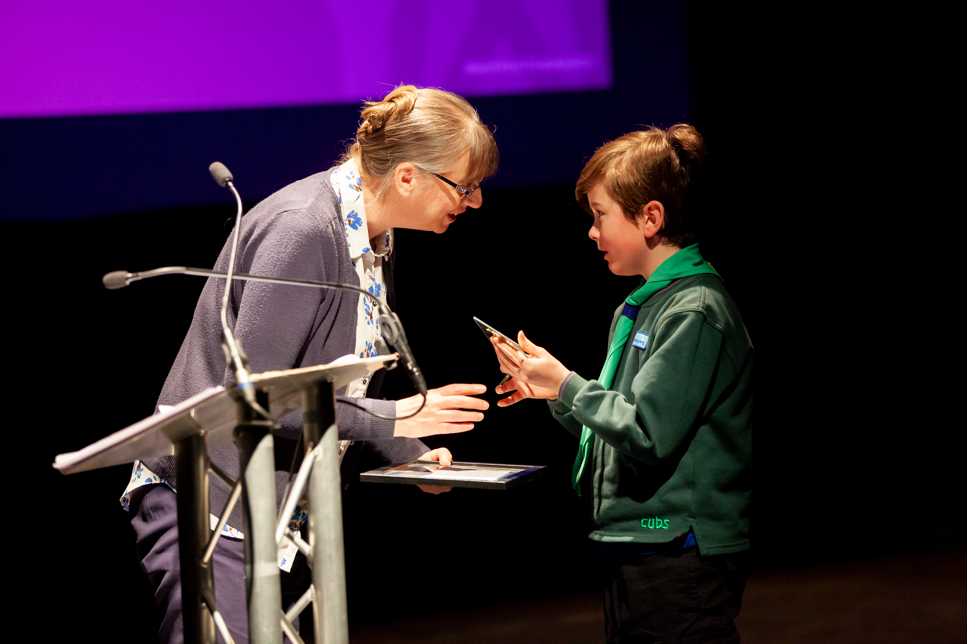 Boy receives award on stage