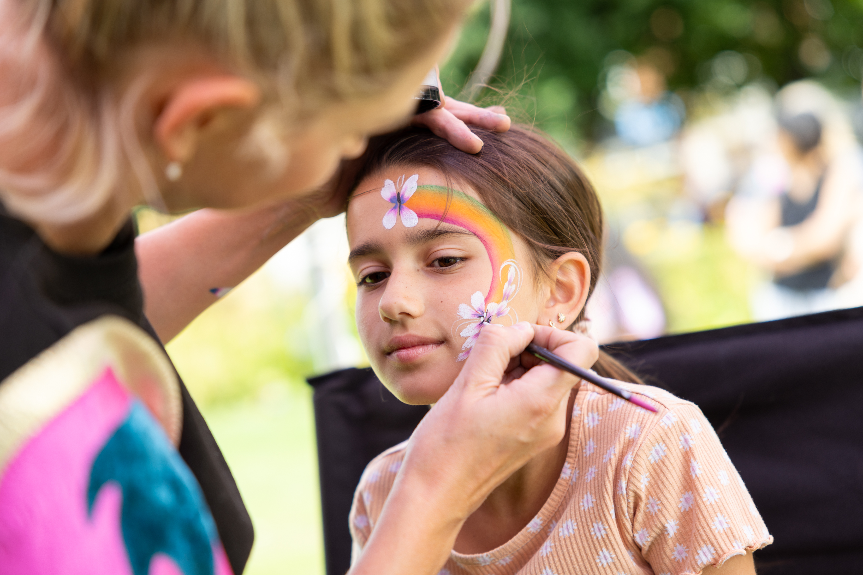 Girl getting face paint done.