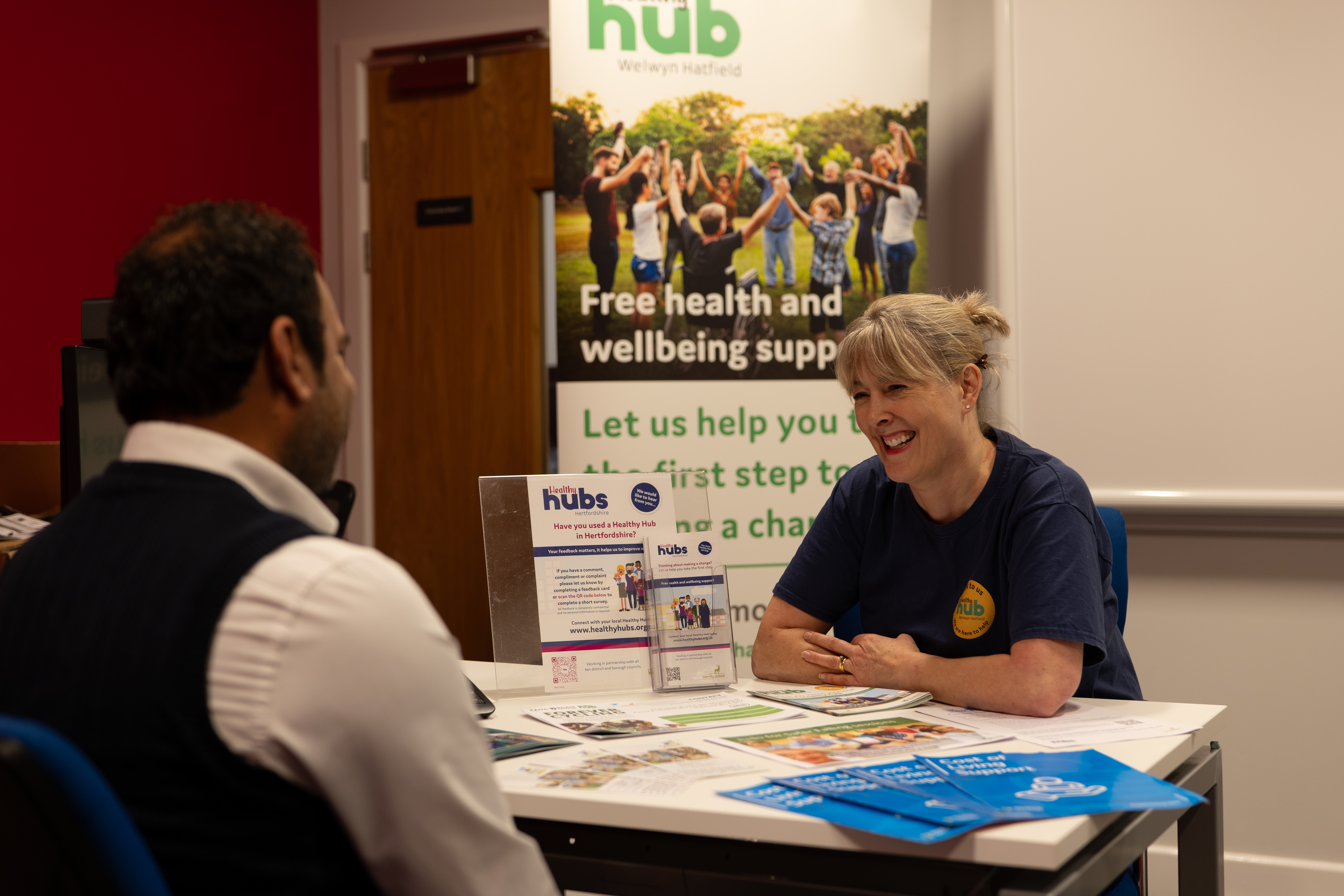 Liz from the Healthy Hub team talking to a gentleman.