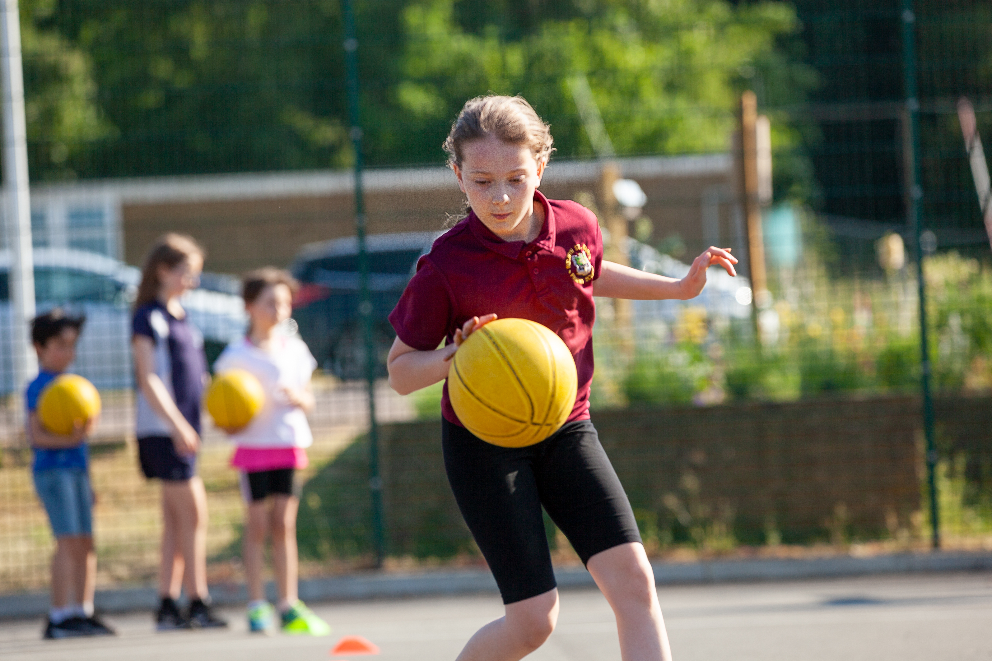 Girl playing basketball on court