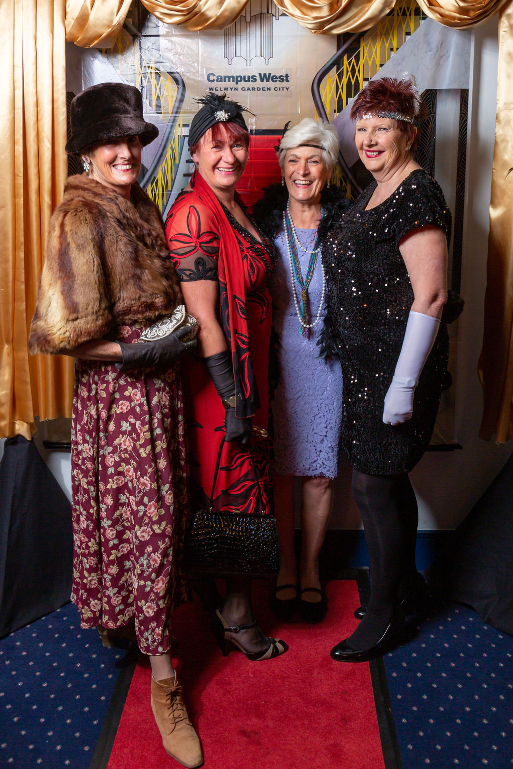 4 ladies in 1920's attire at the Downton Abbey Gala.