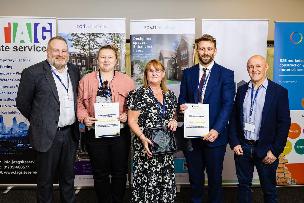 Council officers holding the awards