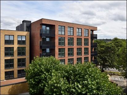 Four and six storey modern brick apartment blocks.