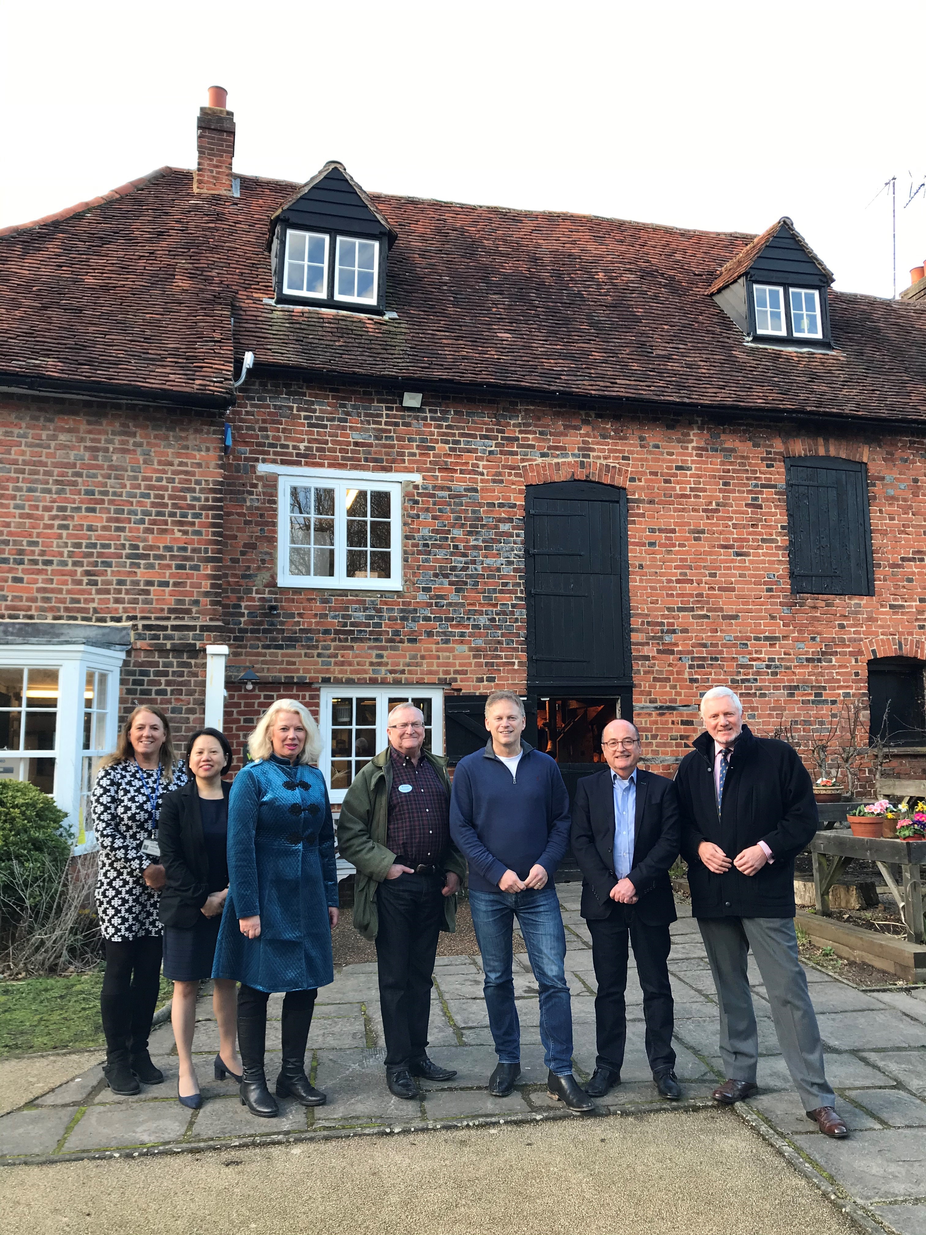 Councillors, MP Grant Shapps, and Chief executive of Welwyn Hatfield Borough Council stand outside of Mill Green Museum and watermill