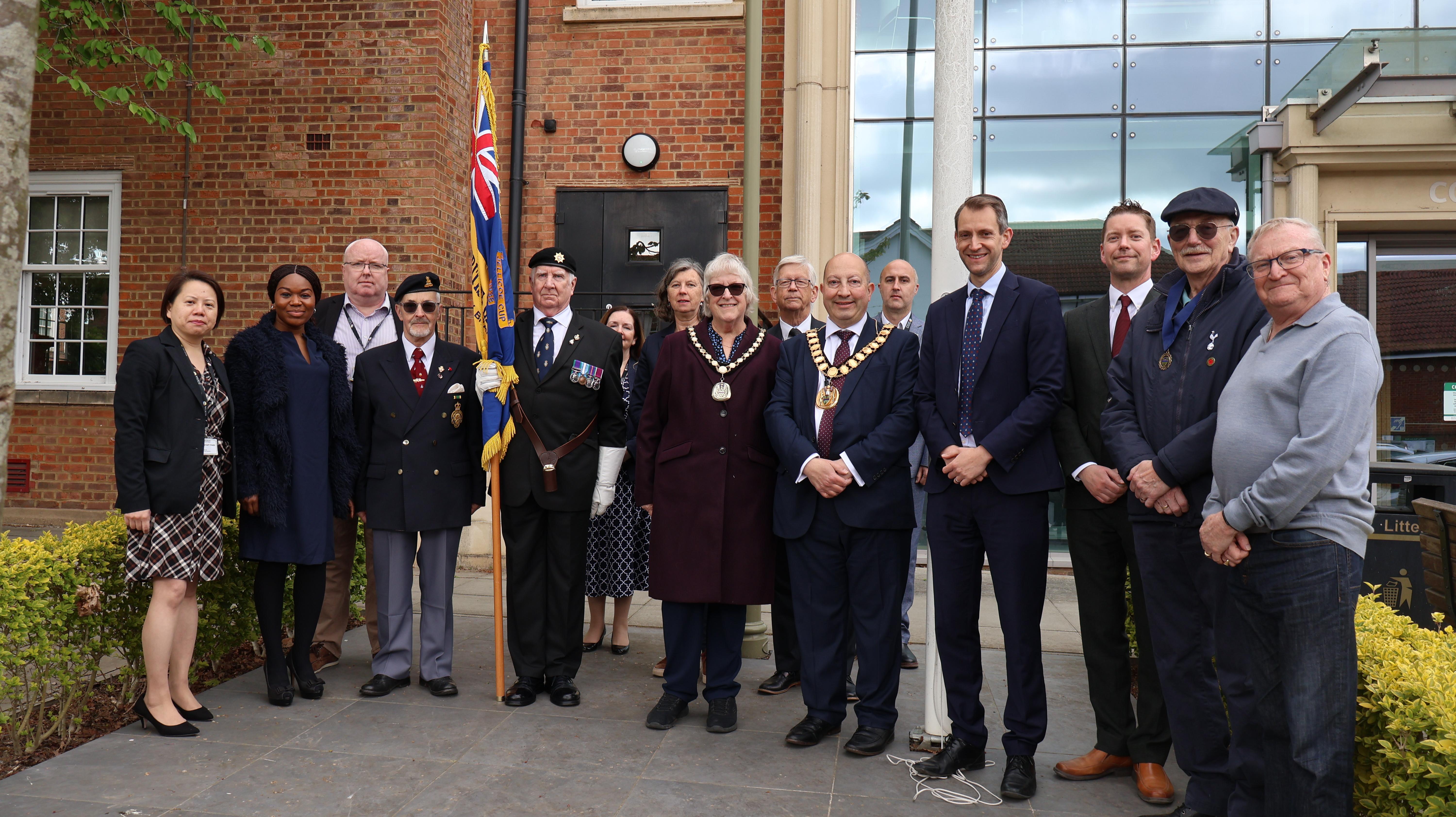 VE Day flag raising 2025 group pictures under the raised flag