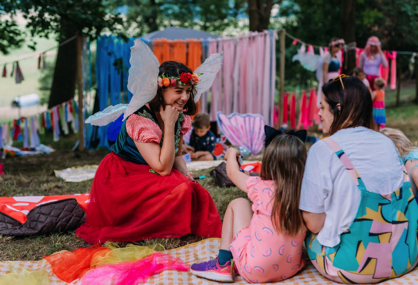 Fairy speaking to a child and mother