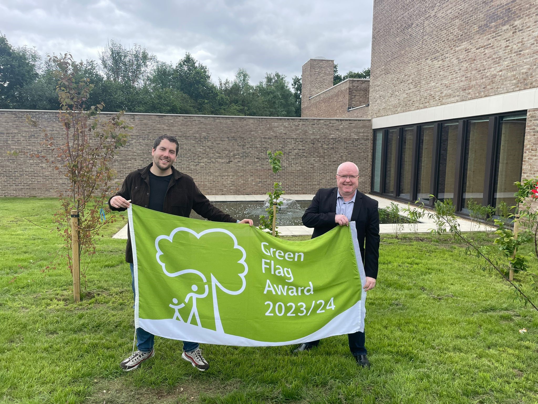 Cllr Holloway and Cllr Russ holding a green flag