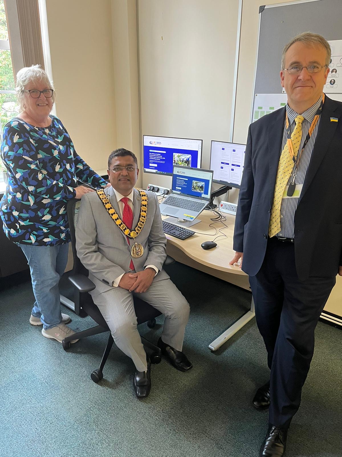 Cllr&#039;s sitting next to a computer with the lottery website on the screen.