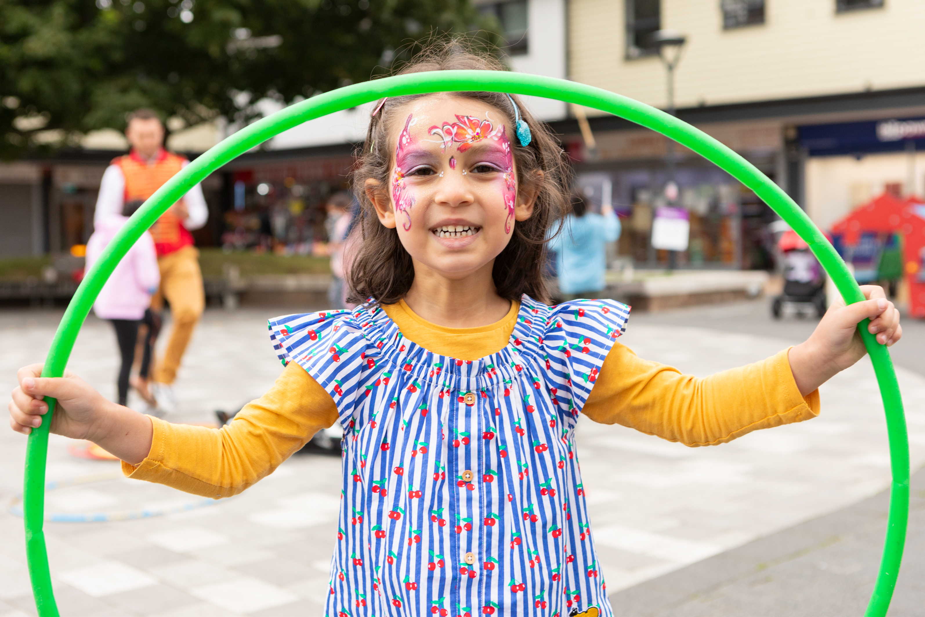 Young girl with hoola hoop and facepaint
