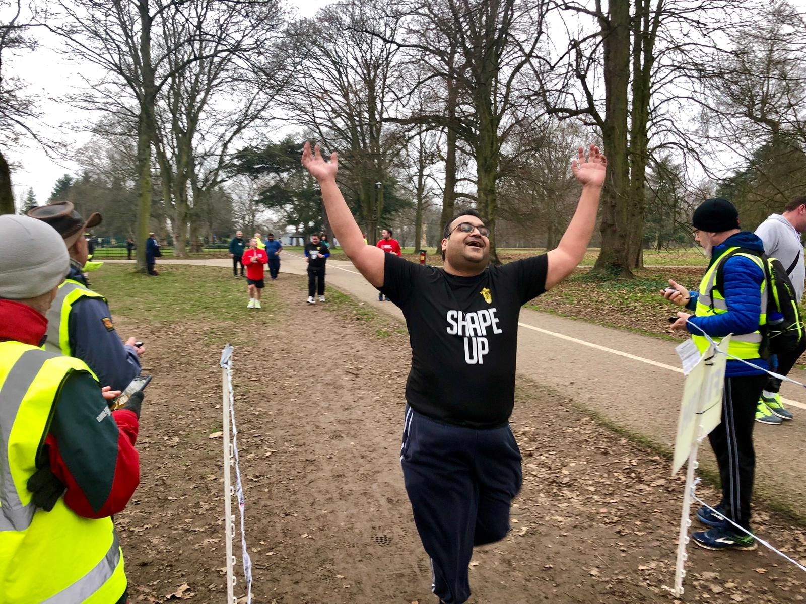 man running through finish line
