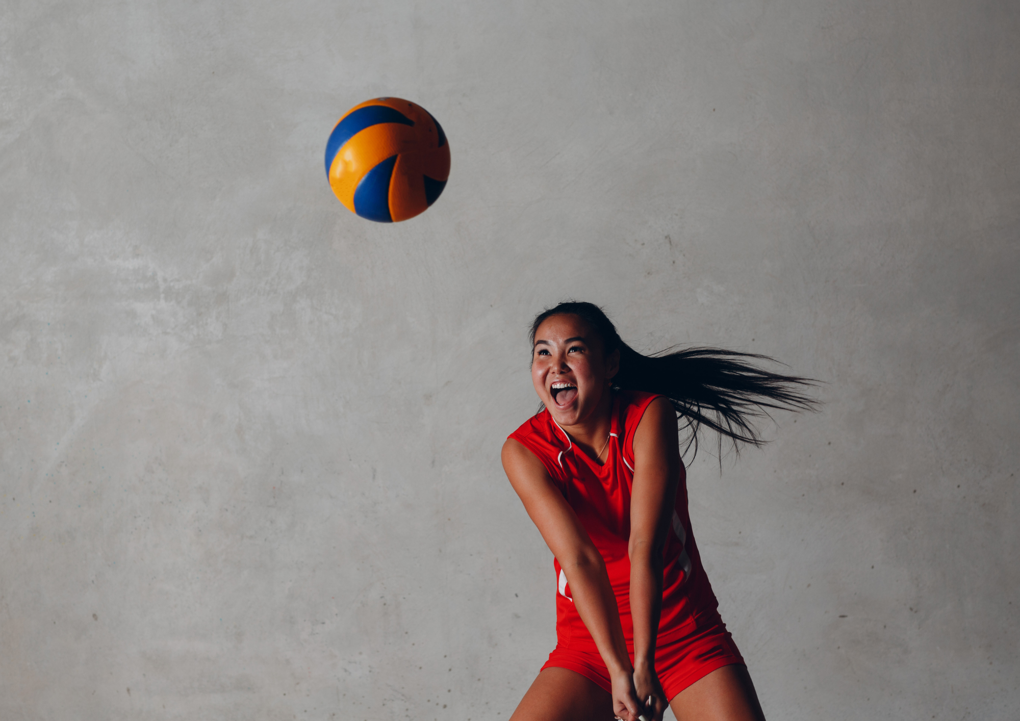 Girl hitting a volleyball.