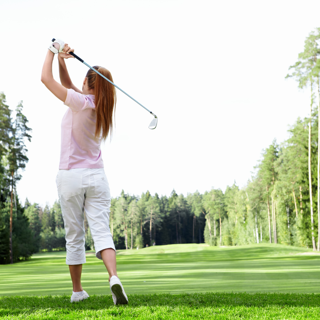 A young girl playing golf