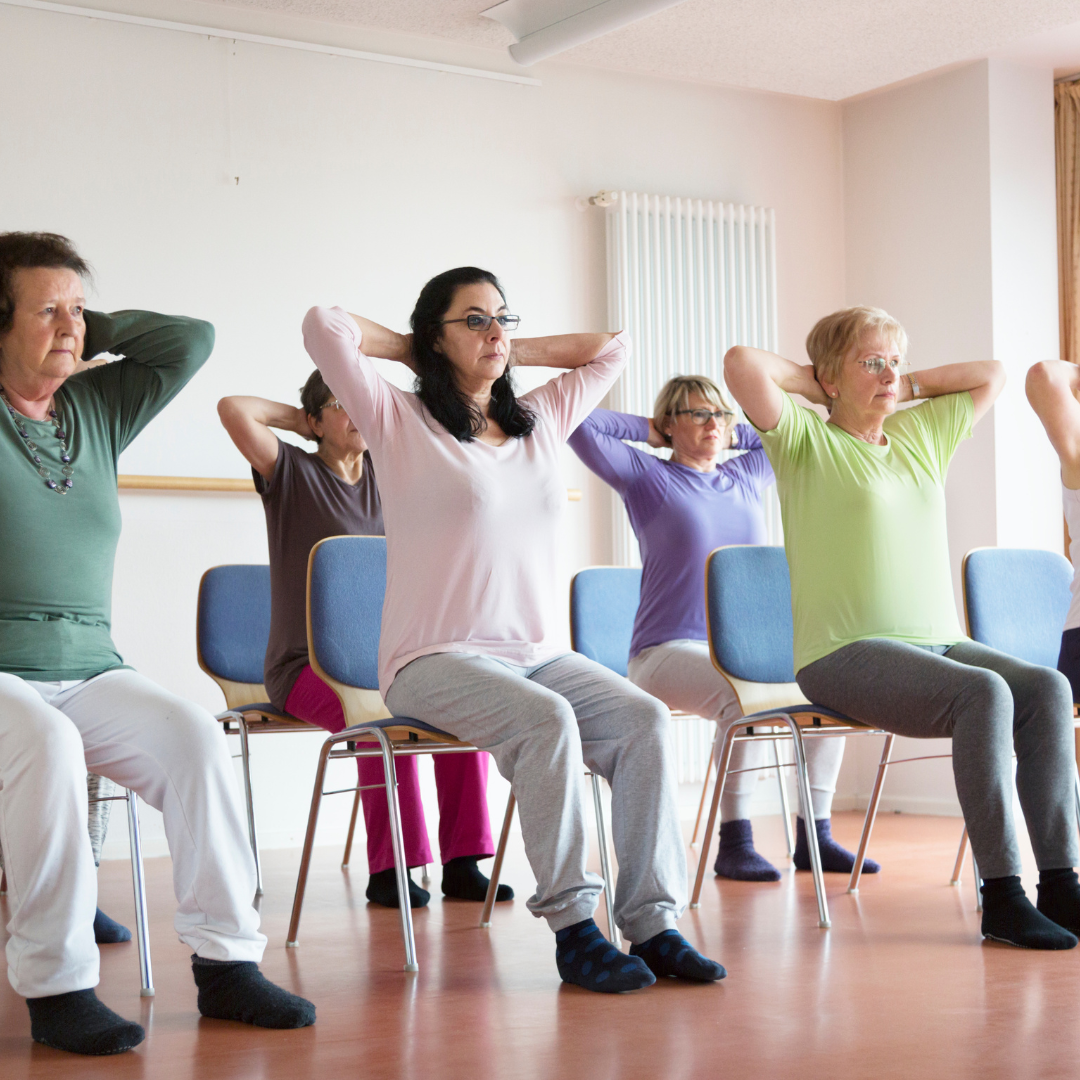A group of women doing yoga on chair