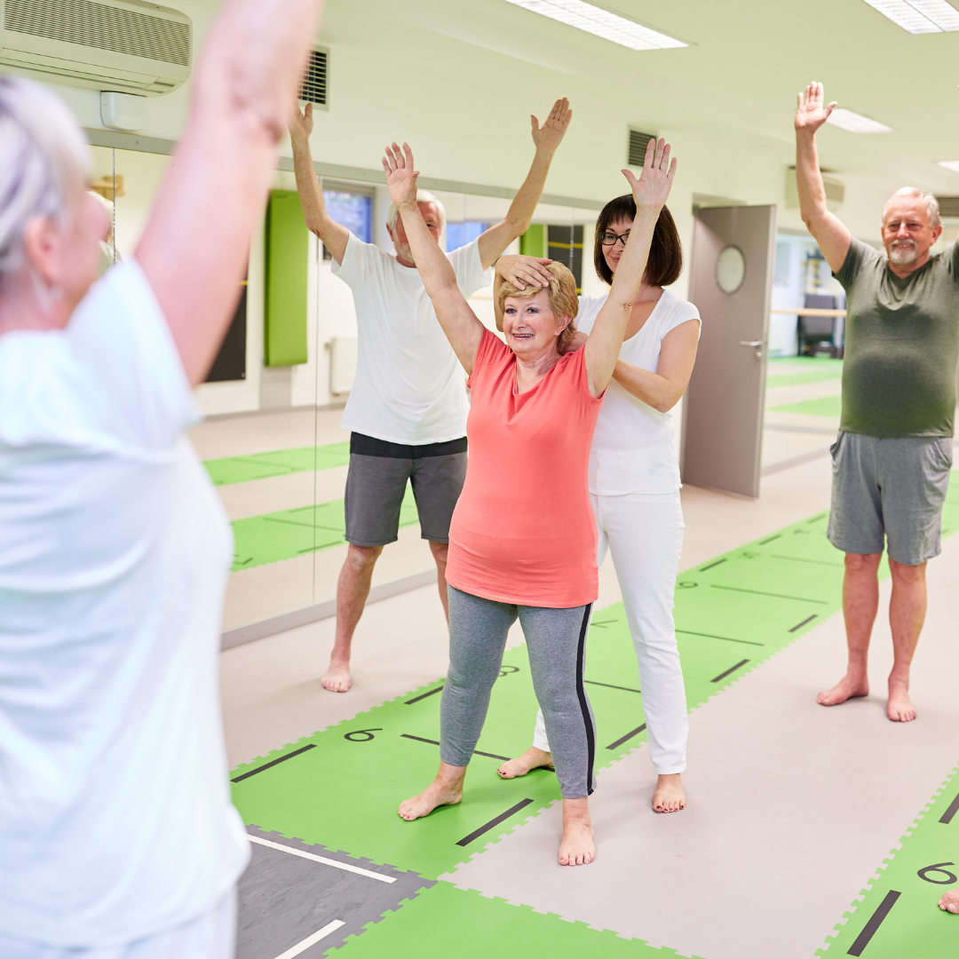 A group of elderly people partaking in an exercise class