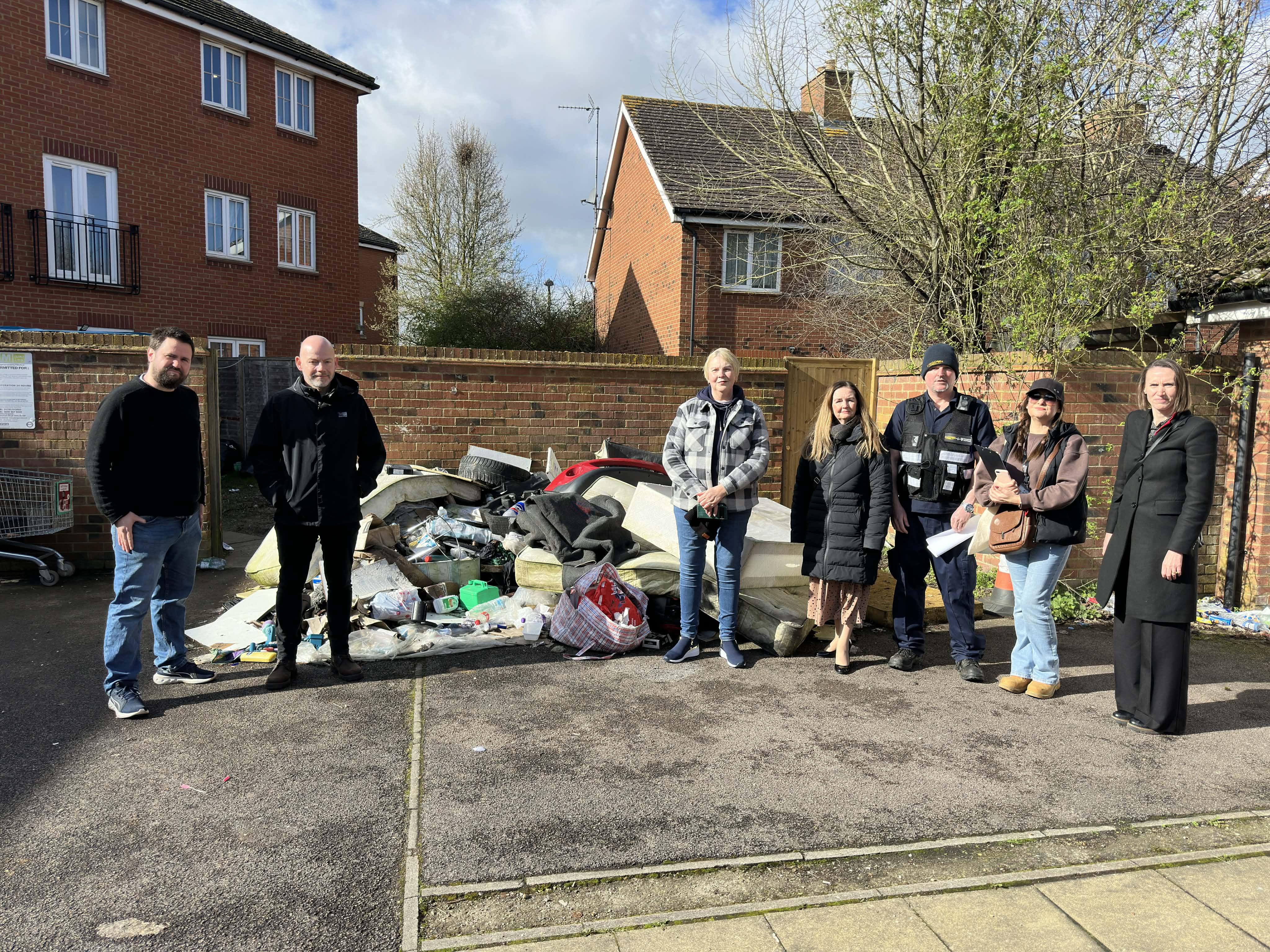 People in front of fly tip