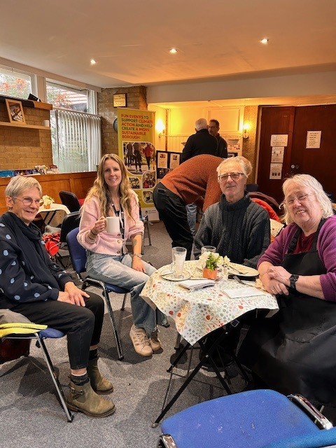 People sitting group holding cups up