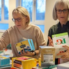 2 ladies looking at tea packets.