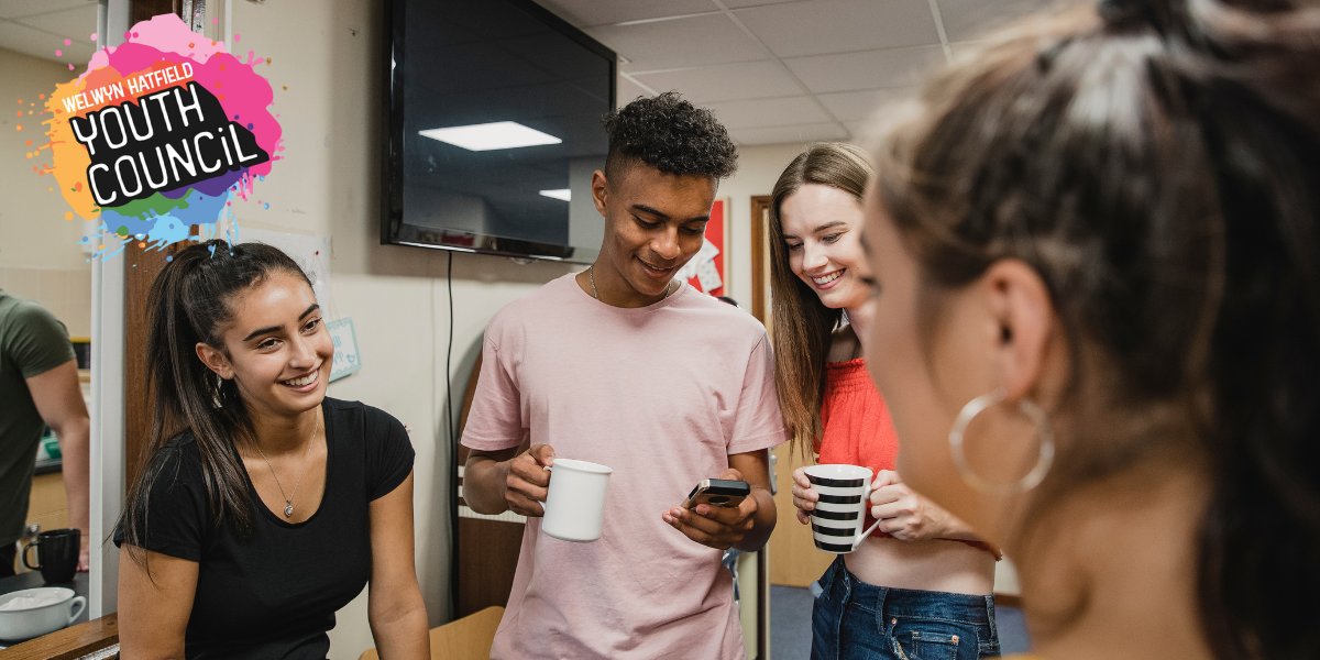 Youths smiling and chatting as a group.