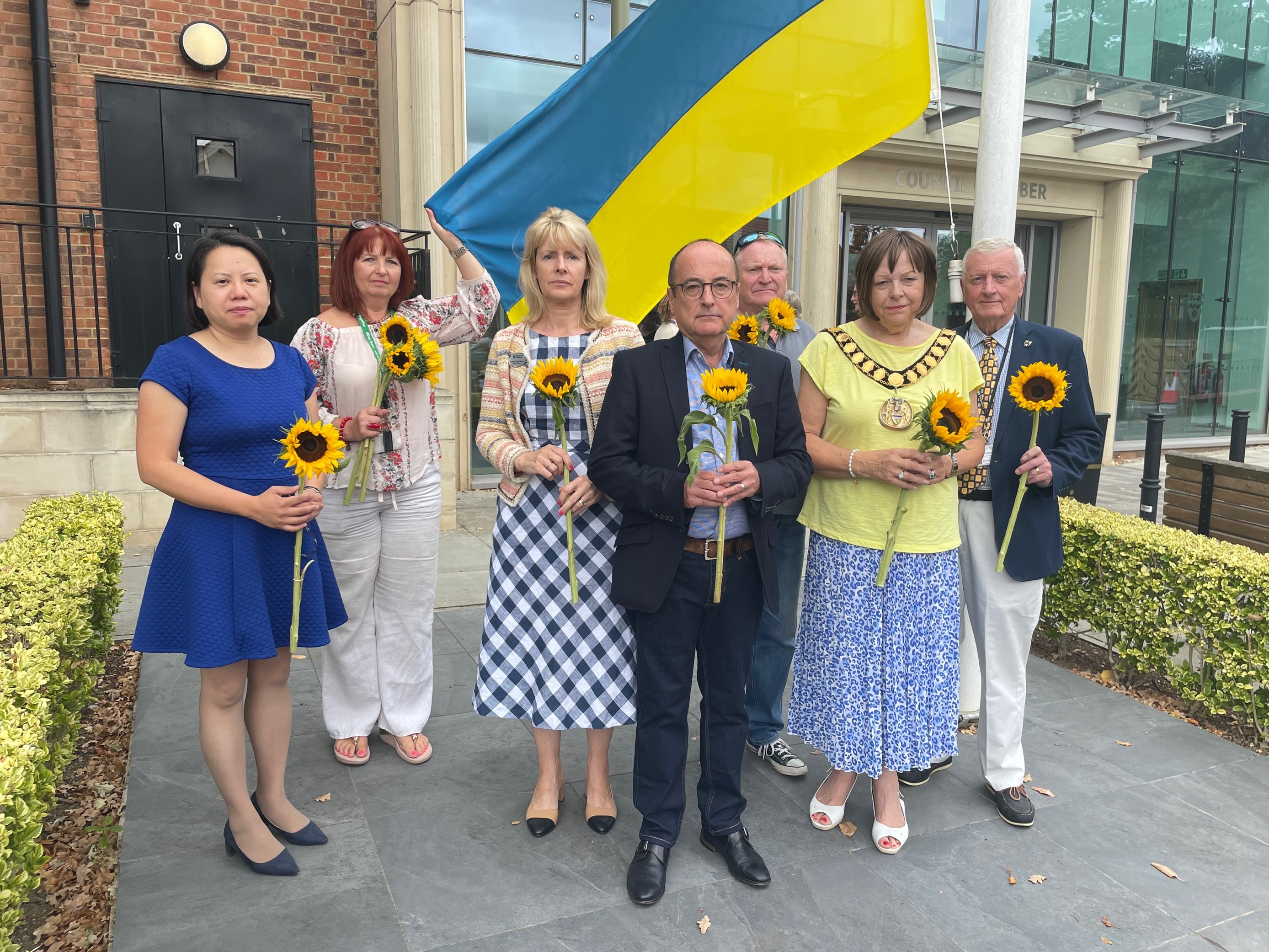 Leaders and Councillors standing in front of Ukraine flag
